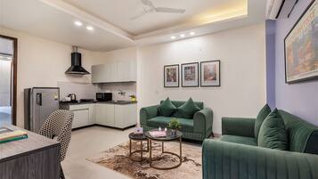 Deluxe Apartment | Living area | 42-inch LED TV with digital channels