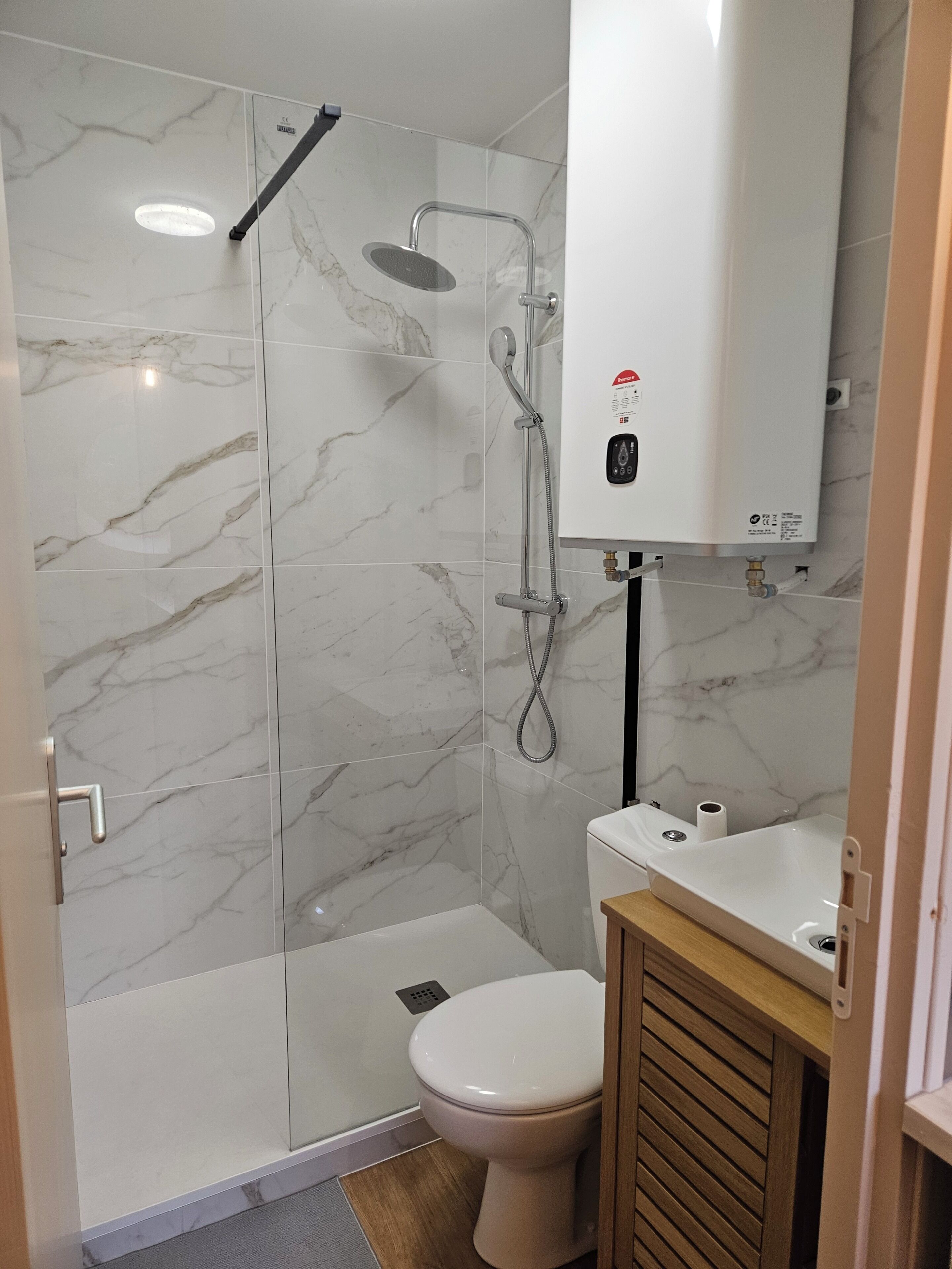 Shower, hair dryer, towels, toilet paper