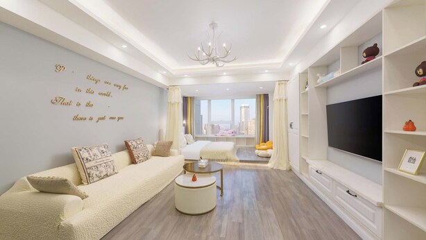 A modern living room with a sofa, coffee table, TV, and city view. - Qingni No. 8 Hotel Apartment (Dalian)