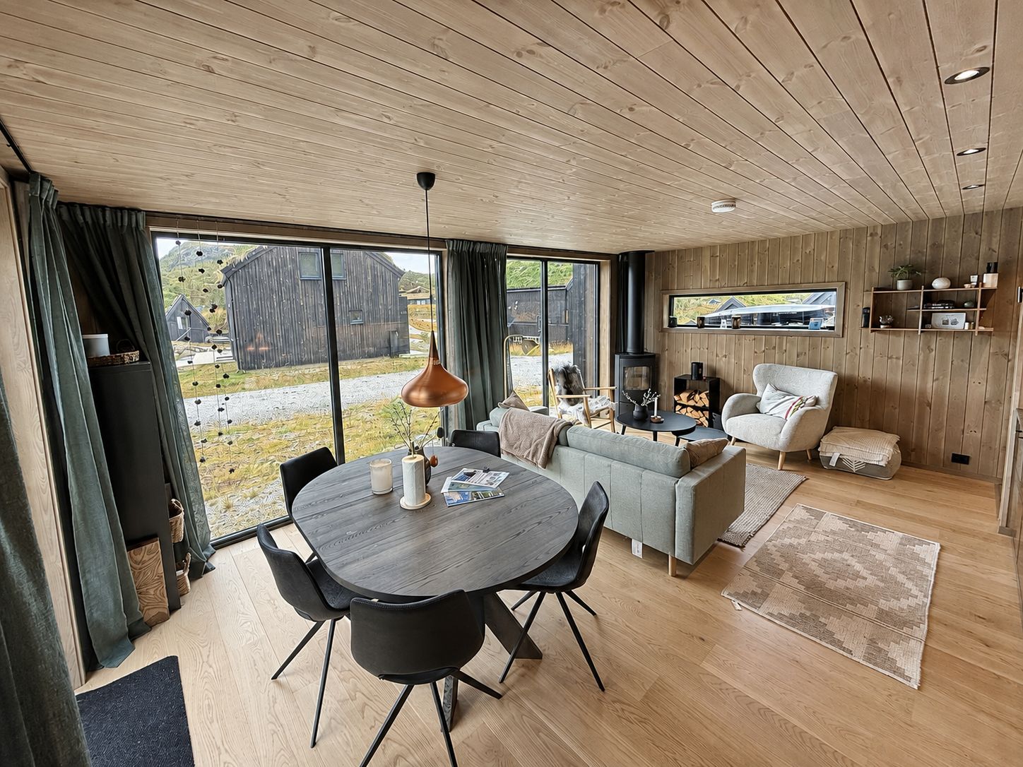 A modern interior with a dining area, sofa, and fireplace.