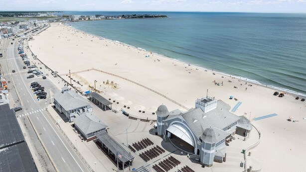A beachside hotel with a large parking area, a central building with a dome, and a view of the ocean. - Ocean Air Suites 300 Feet from Beach, Strip (Hampton)
