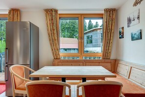 A room with a wooden bench, a table, and chairs.