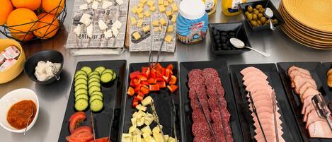 A buffet table with various food items and condiments.