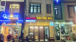 A hotel with a prominent 'HOTEL' sign, a 'WINE & DELICACIES' sign, and a 'CONG PHONG' shop. - Van Nhi MTV Hotel (Xuan Huong - Da Lat)