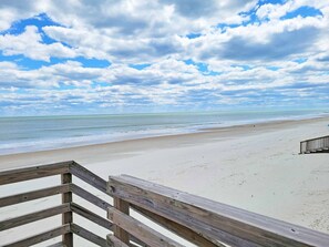 A wooden deck leading to a beach with a view of the ocean and a cloudy sky. - Dog Friendly- Oceanfront Litchfield Beach! The Flag House - Traumerei (Pawleys Island)