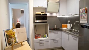 A compact kitchen with a microwave, kettle, and refrigerator. - Casa Gargano Ravello Amalfi Coast (Ravello)