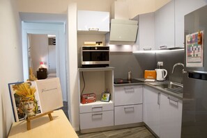 A compact kitchen with a microwave, kettle, and refrigerator. - Casa Gargano Ravello Amalfi Coast (Ravello)