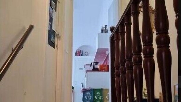 A staircase with a wooden handrail, a light fixture on the wall, and a door leading to another room. - Casa Gargano Ravello Amalfi Coast (Ravello)