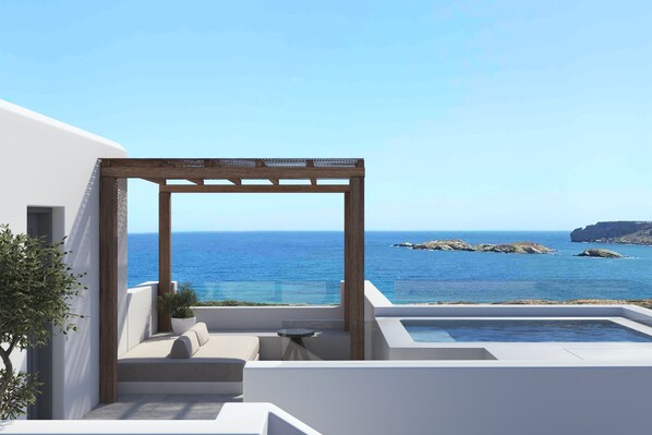A modern outdoor terrace with a pergola, seating area, and a view of the sea. - Parose Suites Santa Maria (Paros)