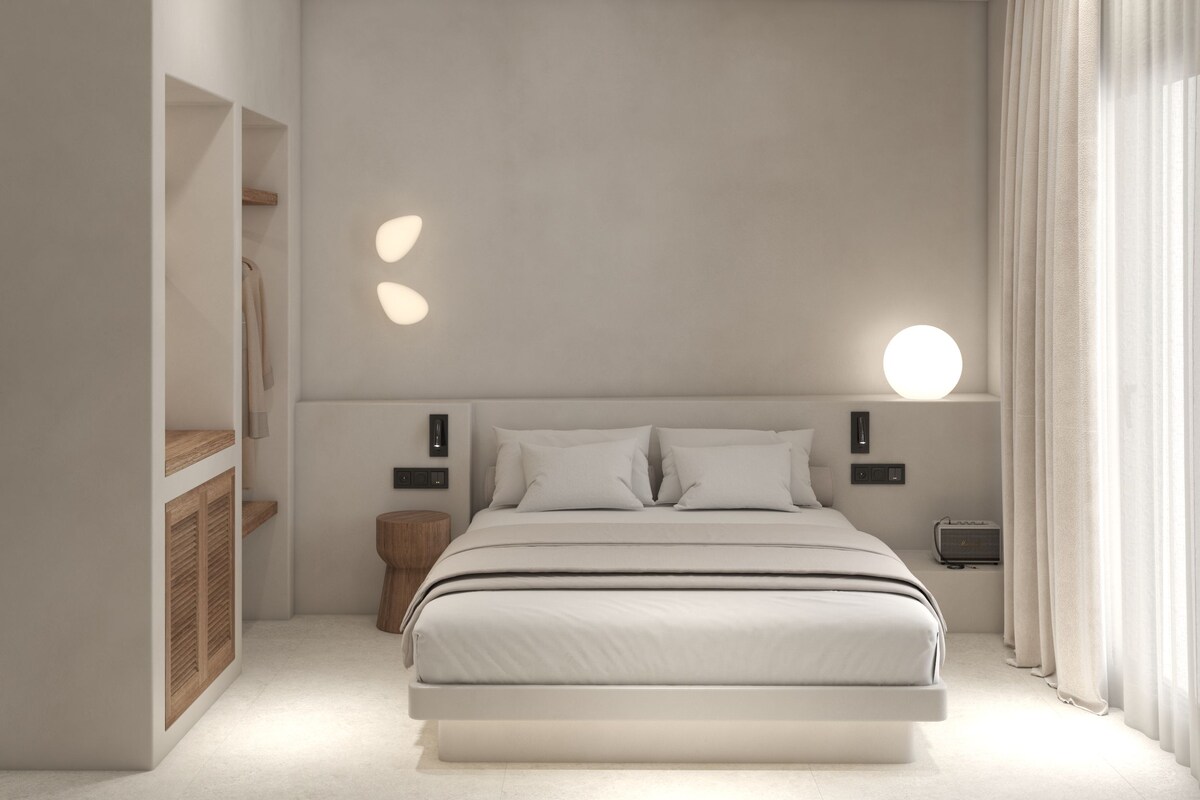 A modern bedroom with a large bed, bedside tables, and a built-in wardrobe.