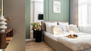 A bedroom with a bed, bedside table, lamp, and artwork. - Perfect Old Town Krakow's Architect Apartment AC WiFi King Size Bed Parking (Kraków)