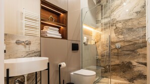 A modern bathroom with a glass-enclosed shower, a marble sink, and a toilet. - Perfect Old Town Krakow's Architect Apartment AC WiFi King Size Bed Parking (Kraków)