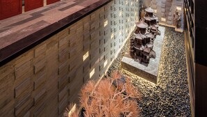 A multi-level interior with traditional architectural elements, a central courtyard, and a seating area. - Manxin Mansion Beijing Shichahai Park Nanluoguxiang (Beijing)