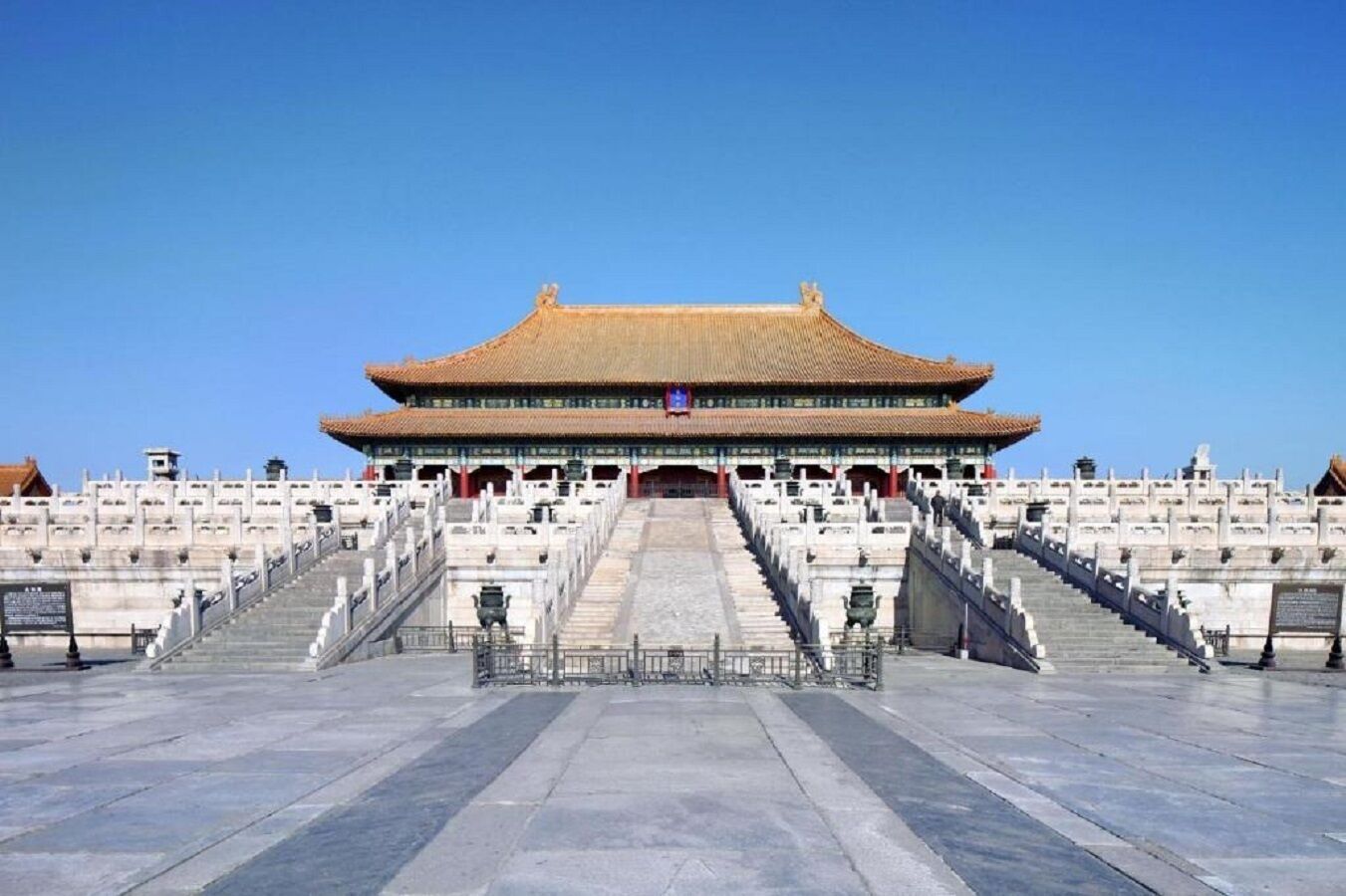 A large, traditional building with a prominent entrance and wide steps leading up to it.