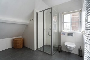 Shower, hair dryer, towels, toilet paper