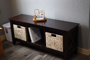 A wooden console table with woven baskets and a children's toy. - Cozy Family Retreat w/ Fire Pit & Game Room (Browerville)