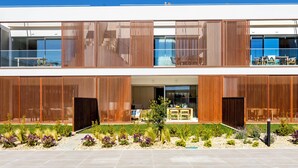 A modern two-story building with a pool, outdoor seating, and a well-maintained garden. - Burgau Sea Garden - Apartment O0 (Budens)