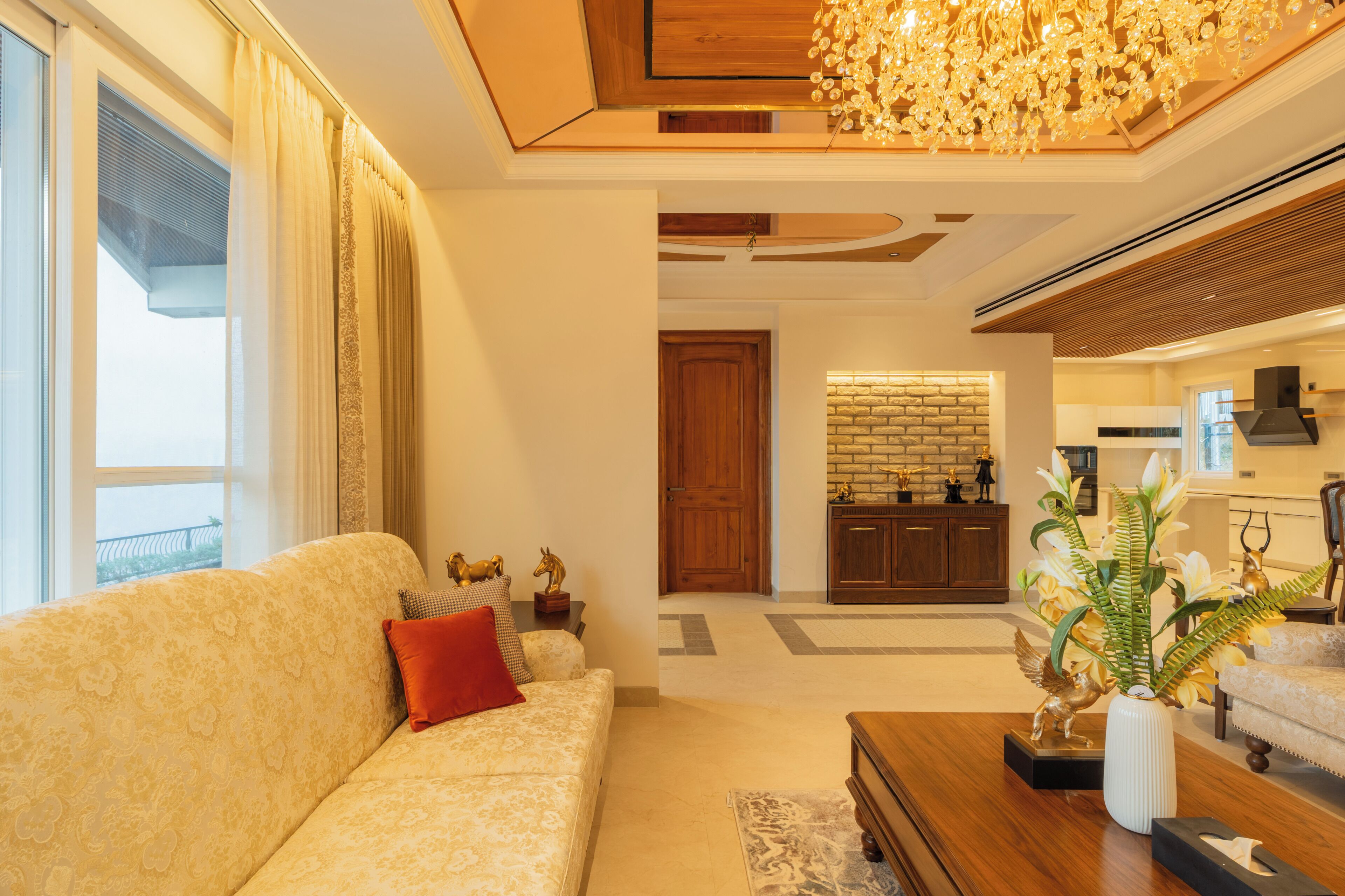 A living room with a sofa, a coffee table, and a decorative vase.