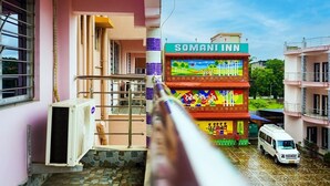 A building with a sign reading 'SOMANI INN' and a colorful mural on the facade. - Somani Inn (Jhargram)