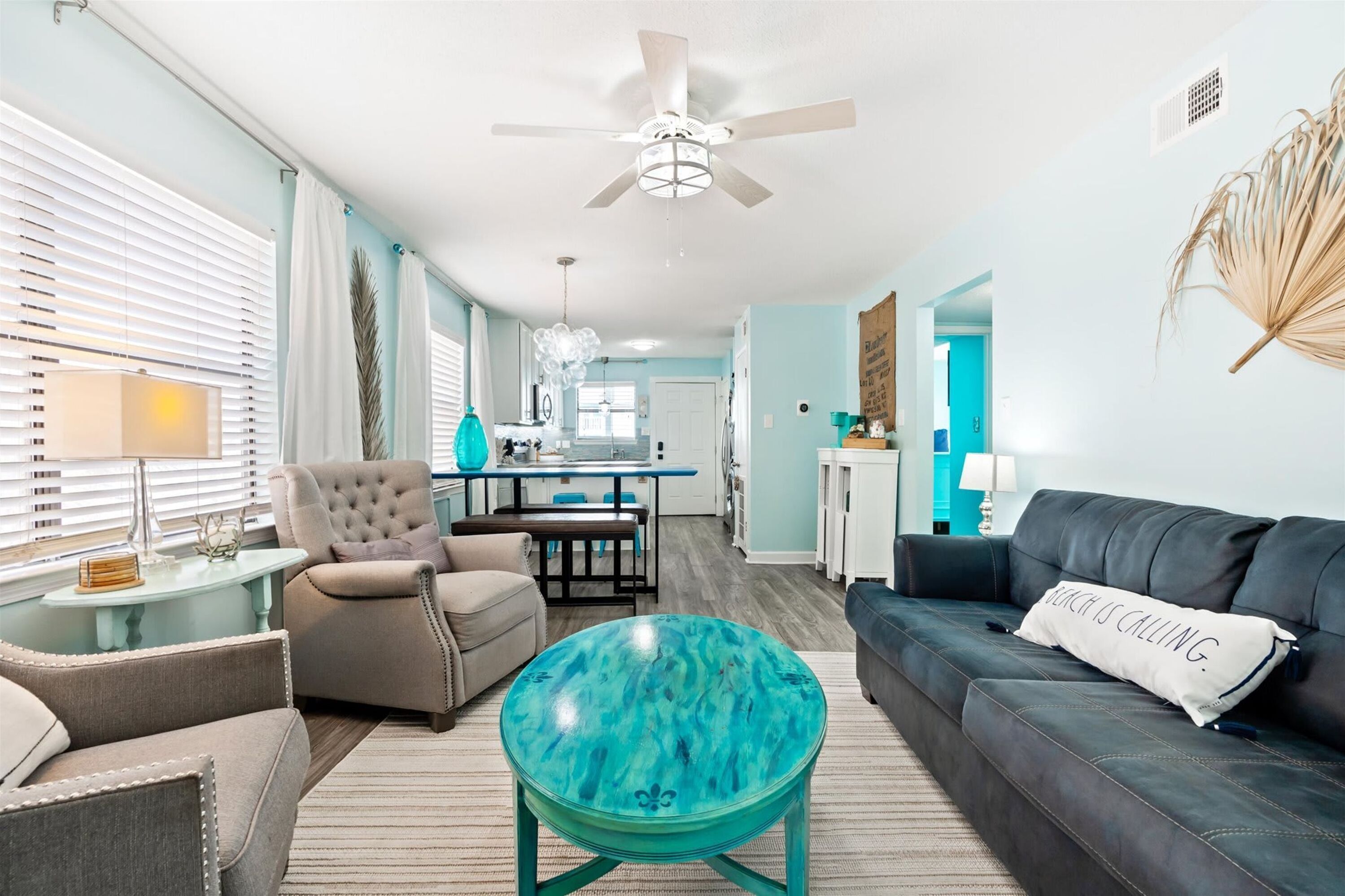 A living room with a sofa, armchair, and round coffee table.