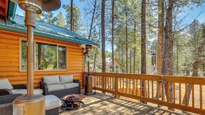 A log cabin with a deck, outdoor furniture, and a wood-burning stove. - Escape to Alpine! Outstanding Cabin w/ Deck & Yard (Alpine)