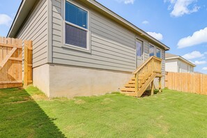 A two-story house with a wooden deck and a small staircase leading to the front door. - Extended Family Getaway! 5 Mi to Gruene District (New Braunfels)