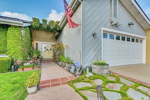 A house with a garage, a well-maintained garden, and an American flag. - 1 Mi to Beach! 'carlsbad Retreat' w/ Serene Garden (Carlsbad)