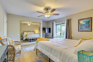 A bedroom with a bed, a ceiling fan, a TV, and a window with curtains. - 1 Mi to Beach! 'carlsbad Retreat' w/ Serene Garden (Carlsbad)