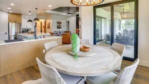 A modern kitchen with a central island, dining area with a round table, wicker chairs, and a large window with a view. - 1 Mi to Boat Ramp! Lake Placid Home w/ Dock (Lake Placid)