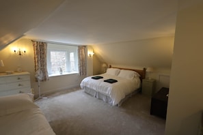 A bedroom with a single bed, a bedside table, a nightstand, a window with curtains, and a ceiling fan. - Forget Me Not - Craigengillan Estate (Dalmellington)