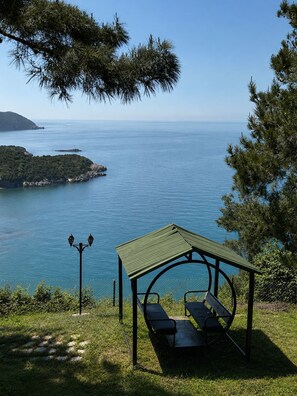 A gazebo with benches overlooking a body of water and a distant island. - DIAMOND KORU HOTEL (Amasra)
