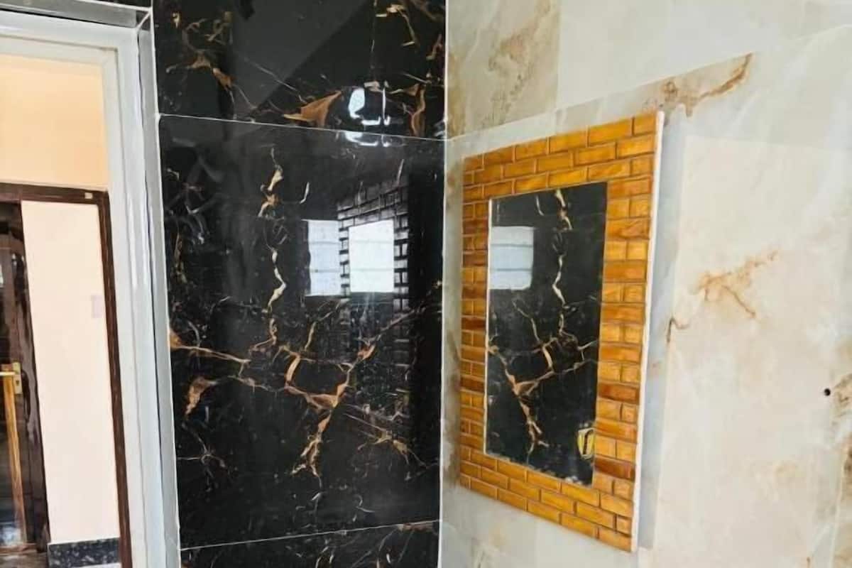 A bathroom with a white sink, a mirror, and a shower area.