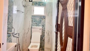 A bathroom with a toilet, shower, and sink. - Hotel BN Palace  (Barakpur)