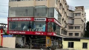 A multi-story building with a sign for 'GHOSH ENTERPRISE' and 'CERAMICS PALACE' on the ground floor. - Hotel BN Palace  (Barakpur)