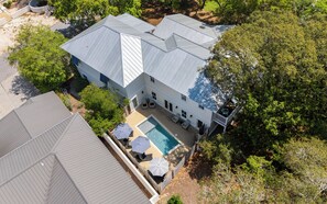 A large house with a swimming pool, surrounded by trees. - Hobnob - Private Pool - Golf Cart (Santa Rosa Beach)