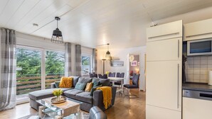 Ein modernes Wohnzimmer mit einer Couch, einem Couchtisch und einem Essbereich.