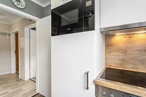 A modern kitchen with a built-in microwave, oven, and stovetop.