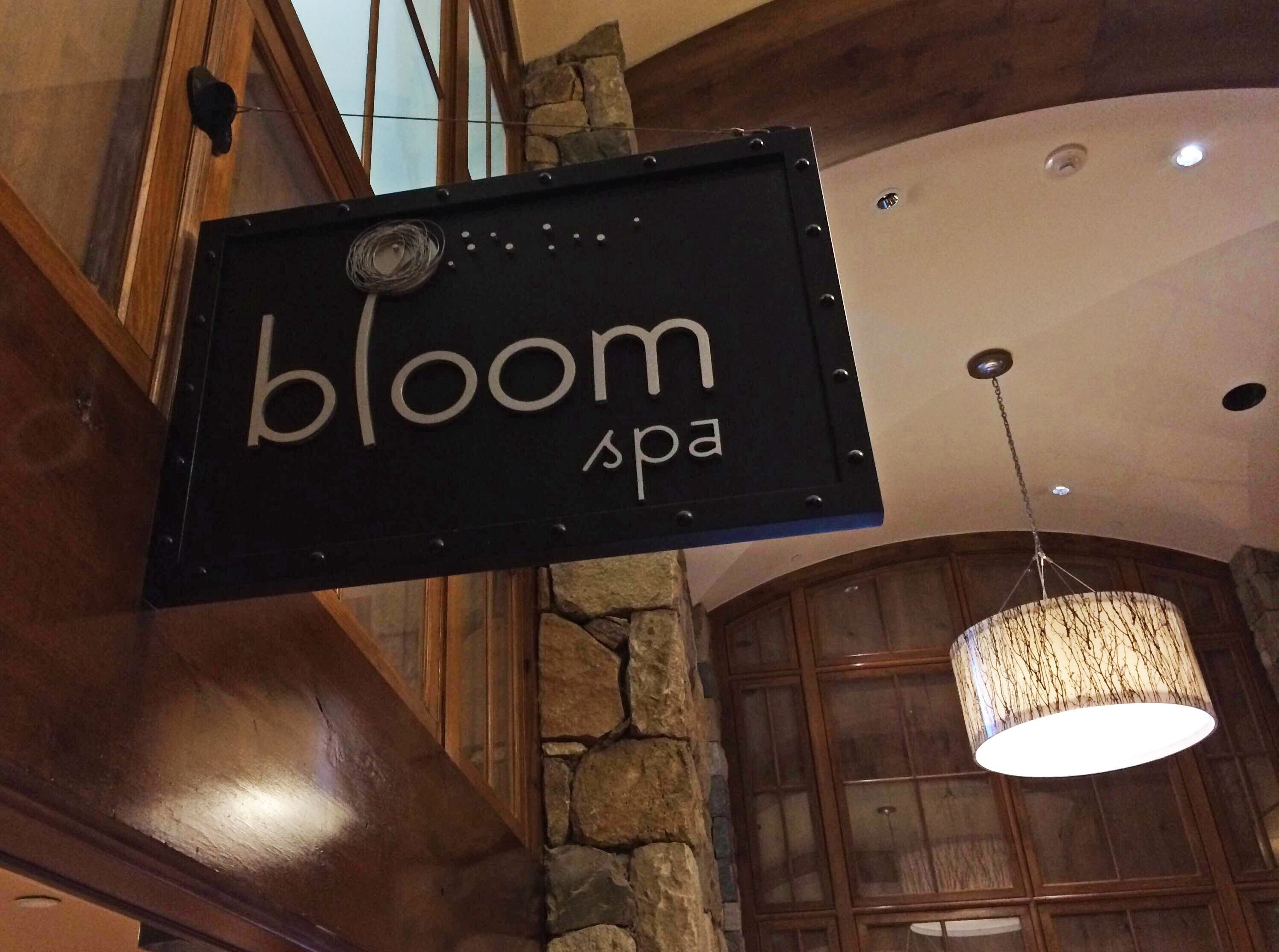 A spa sign with the word 'bloom' and a partial word that could be 'spa' or 'spa.'