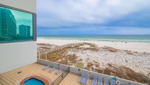 A beach view from a balcony with a pool, lounge chairs, and a wooden walkway. - Phoenix Ix 302 2 Bedroom Condo (Orange Beach)
