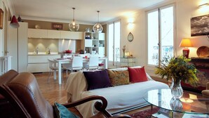 A modern apartment with a dining area, kitchen, and living room. - Marvelous 2-bedroom apartment in Paris perfect for your getaway (Paris)