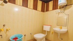 A bathroom with a toilet, sink, and shower. - Hotel Shiri Krishna  (Mathura)