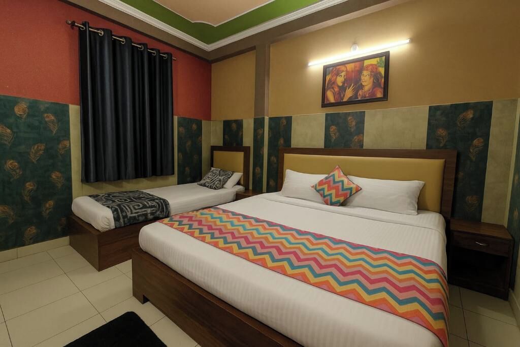 A hotel room with two beds, a window with curtains, a painting on the wall, and a patterned rug on the floor.