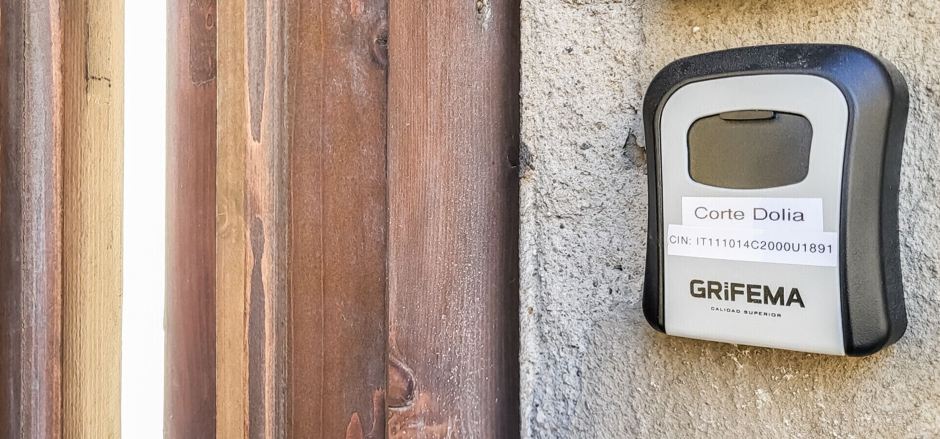 A door with a security card reader labeled 'Corte Dolia' and 'GRIFEMA' on a textured wall.