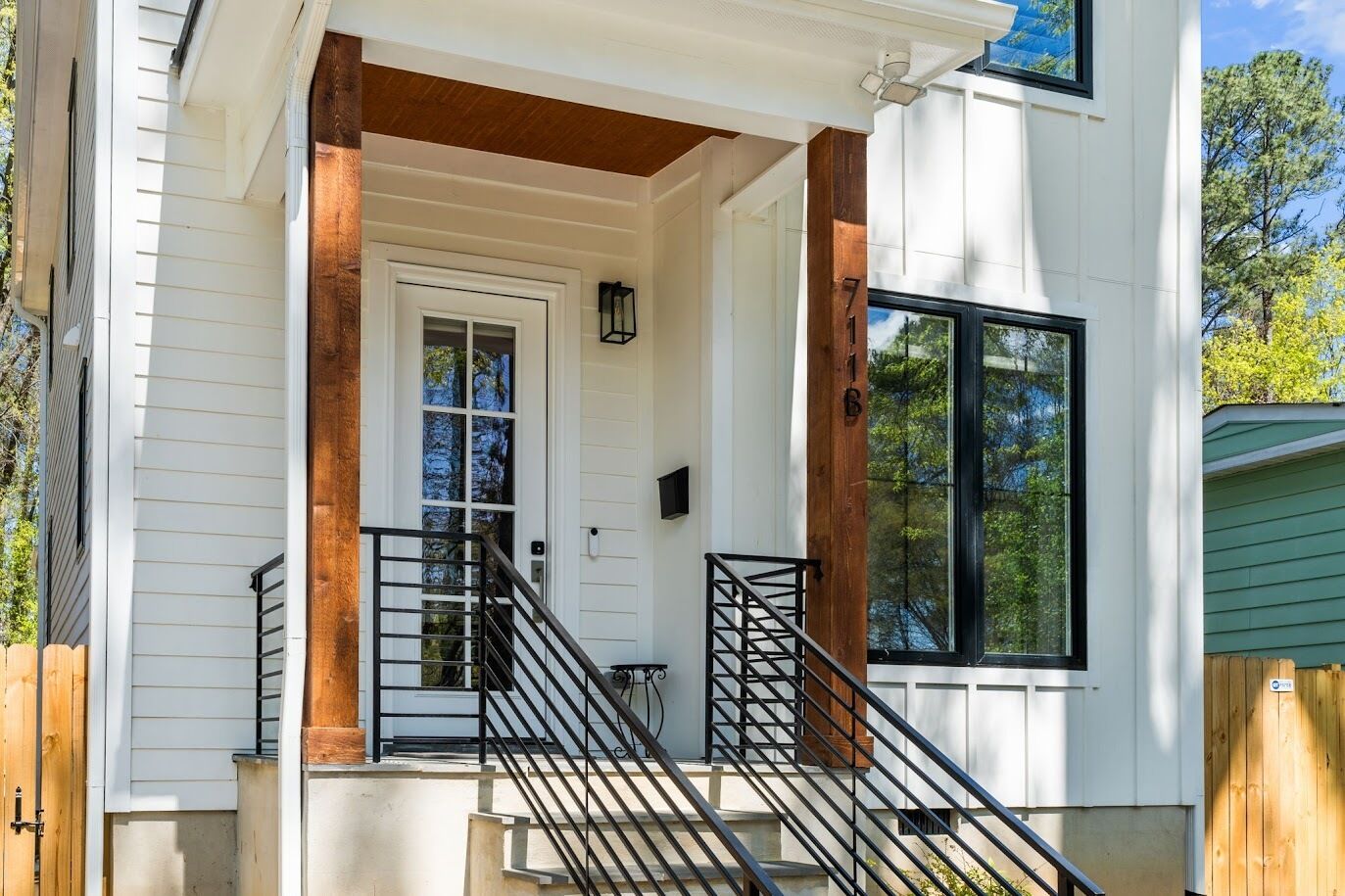 A house with a porch, a staircase, and a door.