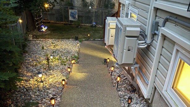 A pathway lined with outdoor lights, leading to a building with a window. - The Cozy Inn (Halifax)
