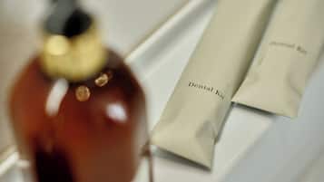 A bottle and a package labeled 'Dental Kit' on a white surface.