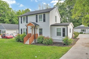 A two-story house with a front porch and a small attached garage. - City Chic: Your Ideal Stay (Charlotte)