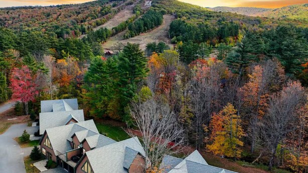 A residential area with houses, a road, and a hilly landscape with autumn foliage. - Cranmore Heights | Luxe, Hot Tub, Walk Downtown (North Conway)