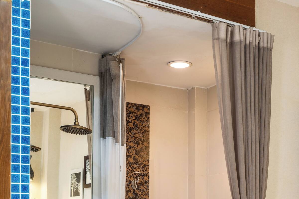 A bathroom with a shower, toilet, and sink.