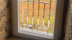 A room with a large window overlooking a river and a town. - Douro View House - Breathtaking views of the Douro River (Lamego)